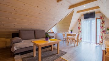 Quadruple Room (2 single and sofa) | Living area | Flat-screen TV