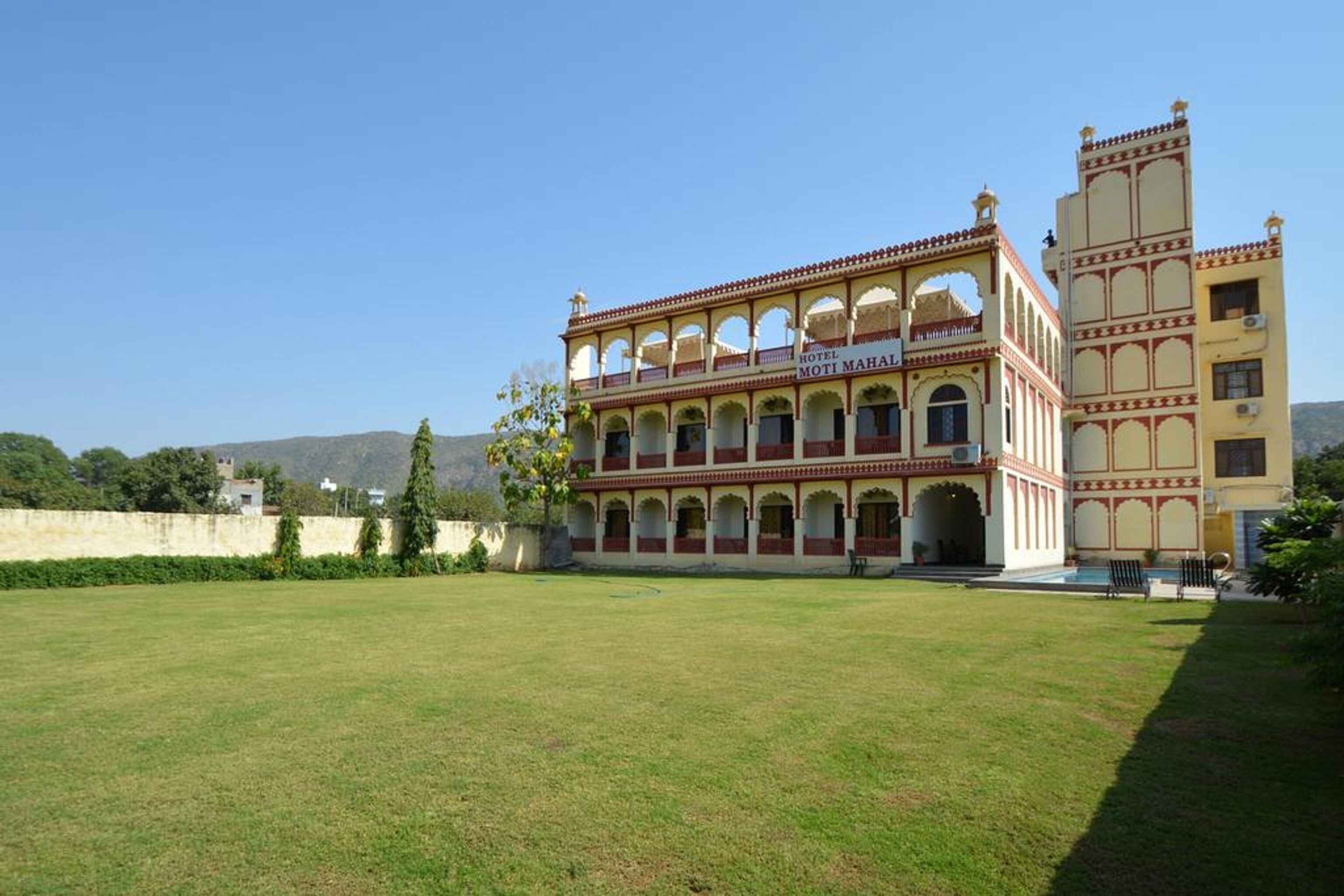A hotel with a traditional architectural style, featuring multiple arches and a courtyard.