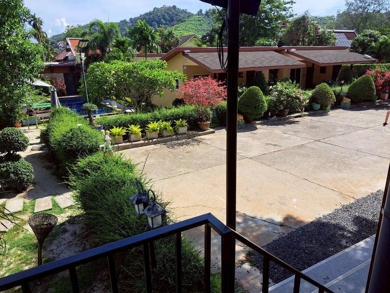 A courtyard with a pool, surrounded by greenery and buildings.