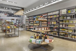 A liquor store with shelves stocked with various bottles and boxes of alcohol.