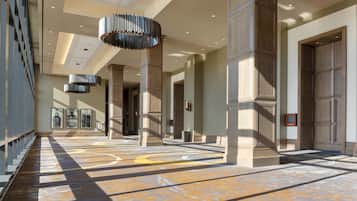 Experience a contemporary and sophisticated atmosphere in our well-designed corridors, featuring tall columns and geometric patterns.