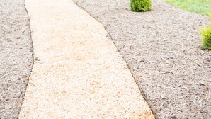 A pathway leading through a landscaped garden with neatly trimmed bushes and a large evergreen tree. - In the center of Nelson County's wine and beer region, 19 miles to UVA/Cville (Afton)