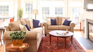 A spacious living room with two sofas, a coffee table, and a fireplace. - In the center of Nelson County's wine and beer region, 19 miles to UVA/Cville (Afton)
