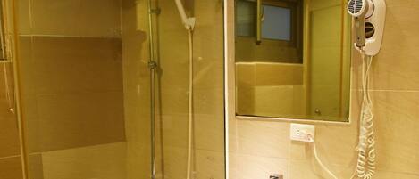 A modern bathroom with a glass-enclosed shower, a white sink, and a toilet.