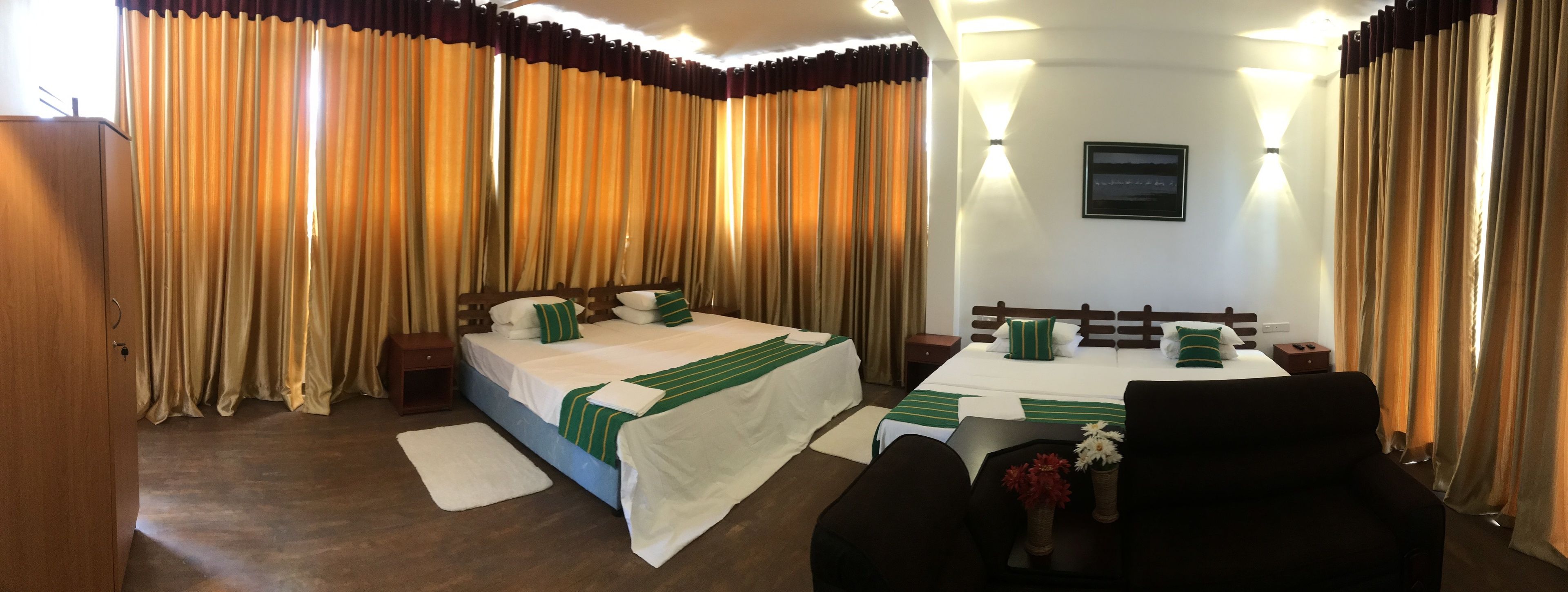 A hotel room with a bed, bedside tables, a desk, and a chair.