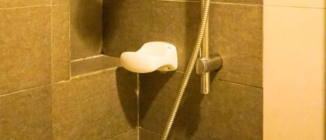 A shower with a handheld showerhead and a handheld faucet.