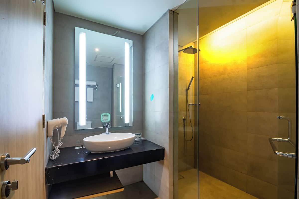 deluxe double room, 1 king bed | bathroom | shower, free toiletries, slippers, towels