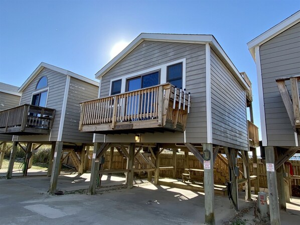 A series of elevated wooden structures with balconies, labeled as "Fish House II," featuring a simple, functional design with a clear view of the surrounding area.