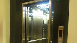 An elevator with a metallic interior and a digital display showing the number 1.