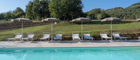 Kolam renang outdoor musiman, dengan kursi berjemur