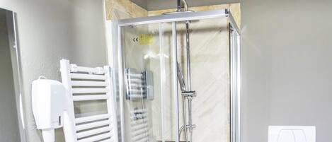 A bathroom with a shower, toilet, and sink.