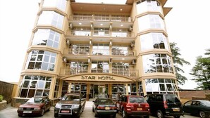 A multi-story hotel with a curved facade, balconies, and a central entrance. - Star Hotel (Bujumbura)