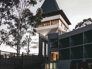 A modern building with a prominent tower and multiple balconies. - The Mitchelton Hotel Nagambie (Mitchellstown)