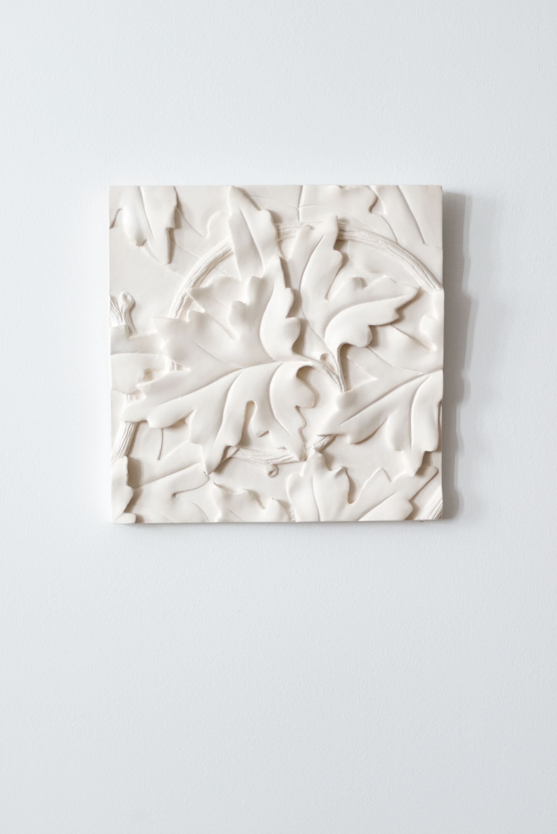 A white textured wall with abstract patterns.