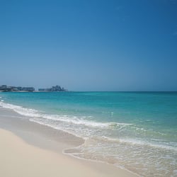 On the beach, white sand, sun-loungers, beach umbrellas