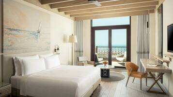 A hotel room with a bed, a desk, a chair, a TV, a painting, and a balcony with a view.