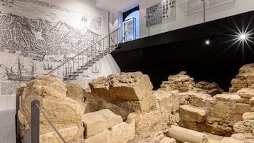 An archaeological exhibit with ancient ruins, a detailed map, and informational panels.