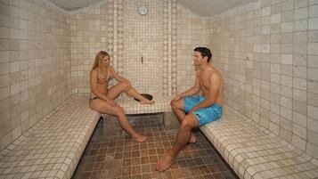 Relax in a serene sauna room with a central bench and two side benches.