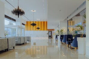 A modern lobby with a chandelier, seating areas, and a reception desk. - Tasia Maris Seasons (Ayia Napa)