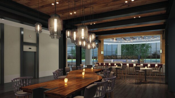 A modern conference room with a large wooden table, multiple chairs, hanging pendant lights, and a view of the outdoors through large windows. - Renaissance Columbus Westerville-Polaris Hotel (Westerville)
