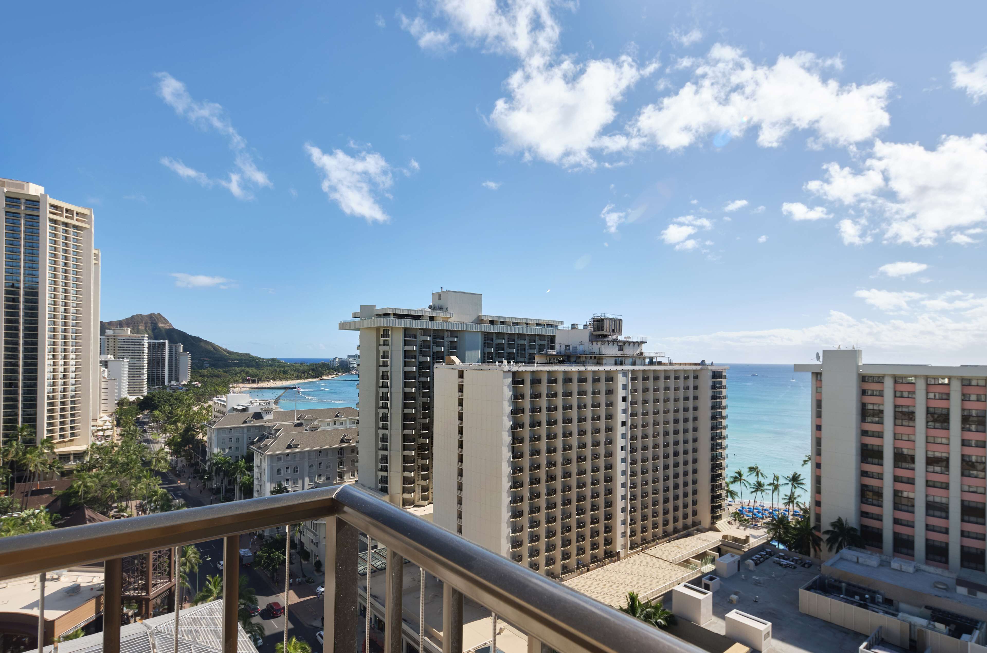 A high-rise hotel with a view of the beach and ocean.