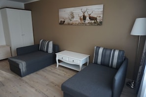 Suite, 1 chambre | Aire de séjour | Téléviseur à écran plat