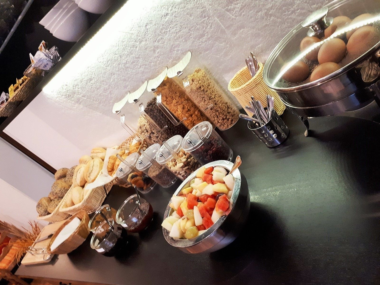 A buffet with various food items and containers.