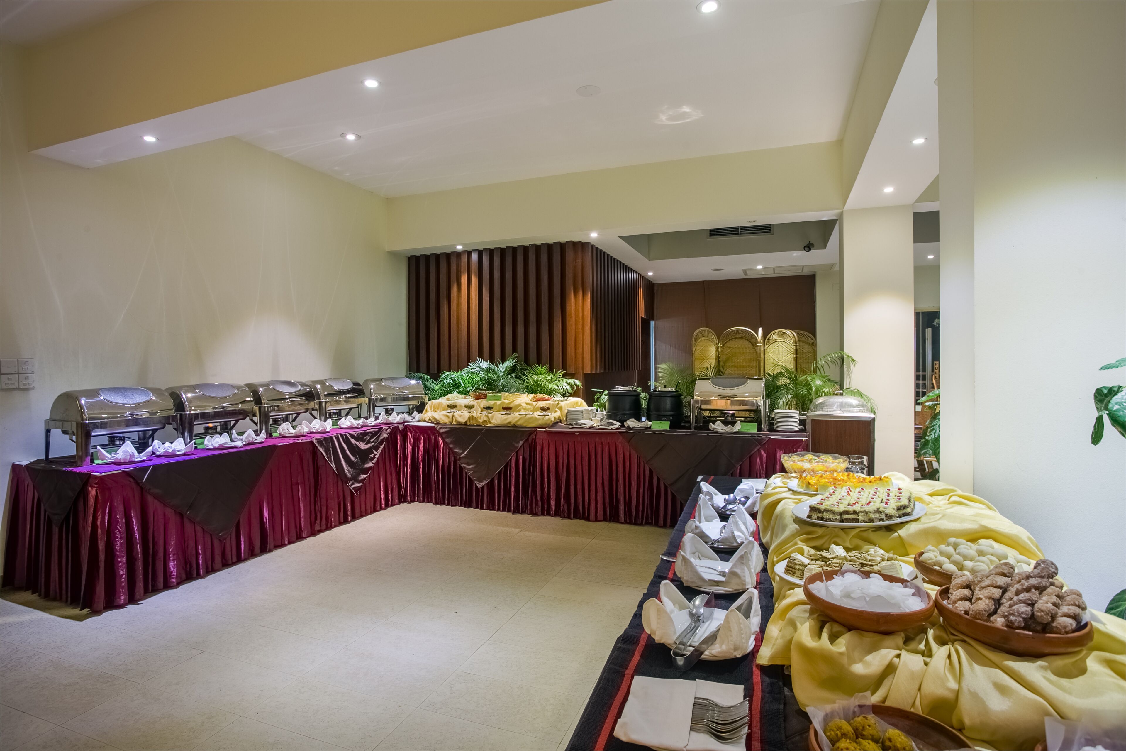A buffet setup with various food items and utensils.