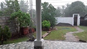 A courtyard with a paved area, a brick wall, and a gate. - The European Gate (Anuradhapura)
