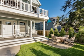 Enjoy outdoor dining and social gatherings on the covered patio with a dining table and chairs.