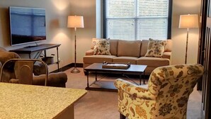 A living room with a sofa, armchair, coffee table, TV, and lamps. - **Bluegrass Getaway** (Lexington)