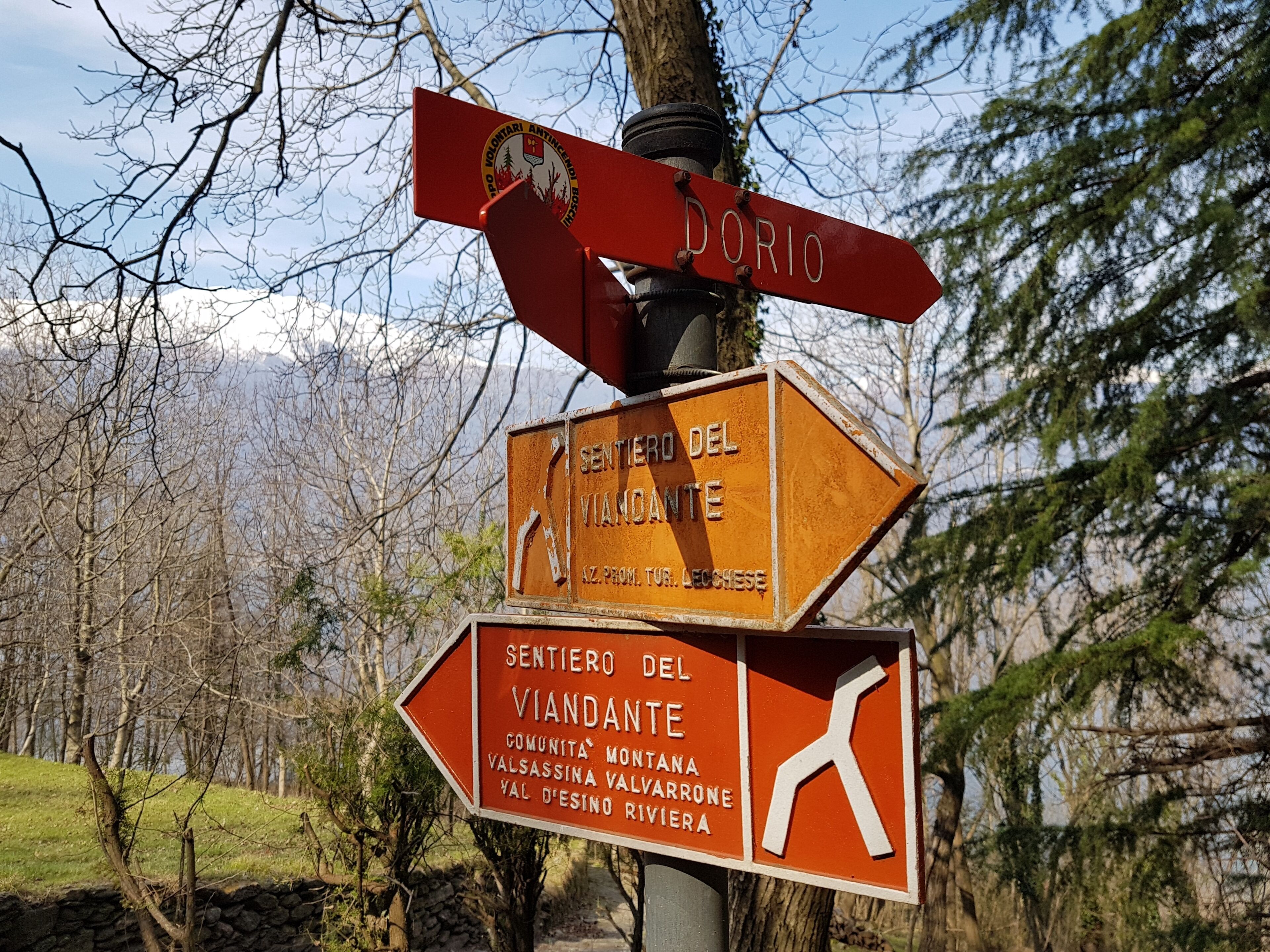 A directional signpost with multiple arrows pointing in different directions, indicating various destinations.