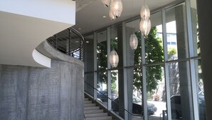 A modern interior with a staircase, metal railings, and hanging pendant lights. - Pearl Pad: Enjoy River, Shopping, Dining.  Balcony, Garage  and free EV chging! (Portland)
