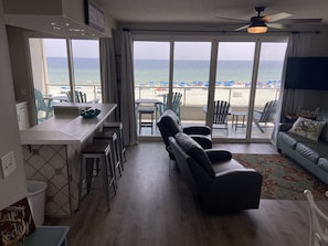 Relax on the balcony with beachside seating, or unwind in the living room with a ceiling fan and ocean views.