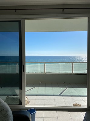 Enjoy ocean views from the comfort of your room, featuring a large glass door and a spacious area to relax.