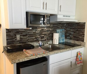 Fridge, microwave, stovetop, coffee/tea maker
