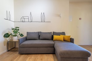 Family Apartment, Garden View | Living area | Flat-screen TV