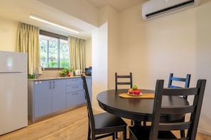 Family Apartment, Garden View | Living area | Flat-screen TV