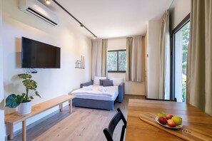 Family Quadruple Room | Living area | Flat-screen TV