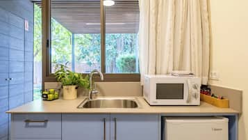 Habitación cuádruple familiar | Zona de estar | Una televisión de pantalla plana