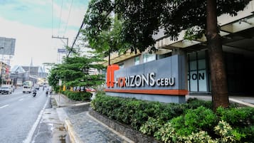 Experience the vibrant atmosphere of HORIZONS Cebu, set amidst lush green surroundings and a striking architectural design.