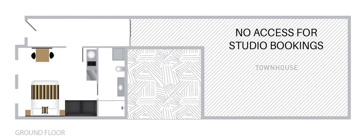 A ground floor layout of a townhouse with a kitchen, dining area, and a living room. There is a note indicating no access for studio bookings.