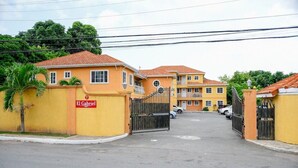 A gated residential area with a yellow building labeled "El Gabriel." - Furnished 1 bedroom Apartment in Gated Complex  (Kingston)