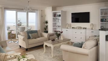 Flat-screen TV, DVD player, books, stereo