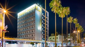 A multi-story hotel with a modern design, featuring balconies on each floor and a bright exterior lighting. - Super Hotel Miyazaki (Miyazaki)