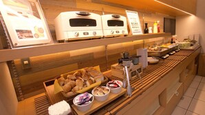 A breakfast buffet with various food items and two ovens. - Super Hotel Miyazaki (Miyazaki)