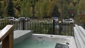 A hot tub with a view of a forested hillside. - Beautiful park like setting- Telluride Lodge Condo  (Telluride)