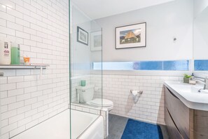 Bathtub, hair dryer, towels, soap