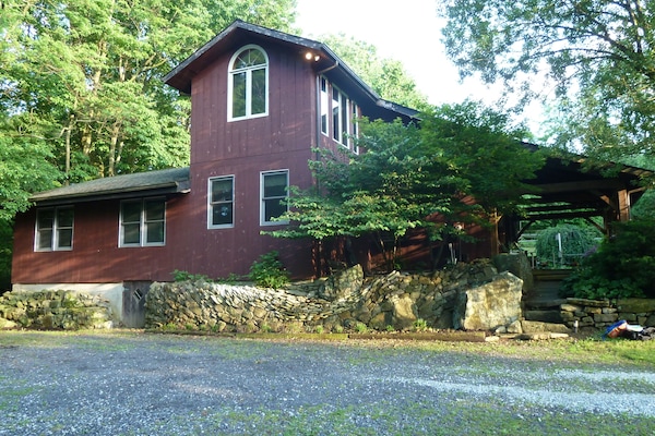 Secluded post-and-beam construction home surrounded by woods.