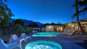A pool area with lounge chairs and a hot tub, surrounded by a house and mountains in the background. - Desert Modern by Jack Meiselman with Pool/Spa (Palm Springs)